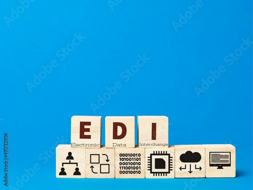 Electronic data interchange concept with icons on wooden cubes.