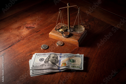 Banknotes and balance with coins on a wooden table. Money management, financial plan. Finance concept.