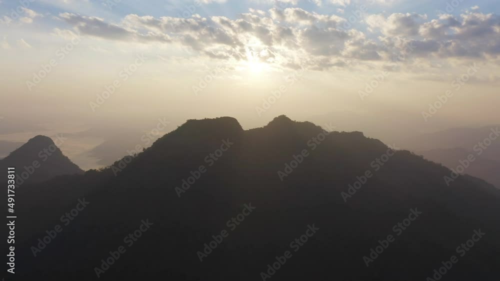 Aerial top view of forest trees and green mountain hills with fog, mist and clouds. Nature landscape background, Thailand. Aerial top view of forest trees and green mountain hills with fog, mist and clouds. Nature landscape background, Thailand.