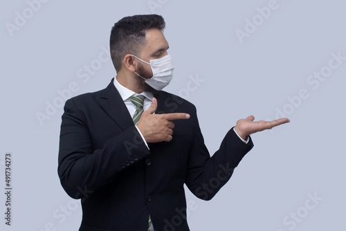 isolated businessman using mask to protect himself from viruses