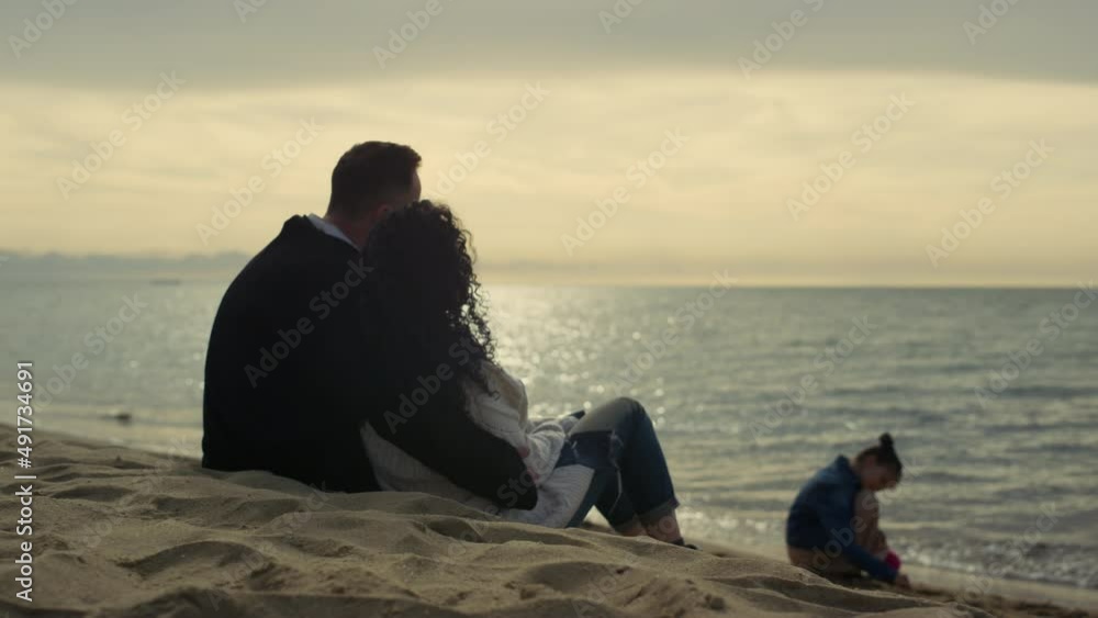 Family looking sunset beach on sea vacation. People enjoying time at shoreline. Family looking sunset beach on sea vacation. People enjoying time at shoreline.