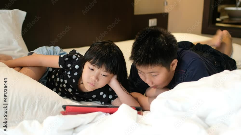 two children addicted tablet, asian kid watching cartoon
two children addicted tablet, asian kid watching cartoon