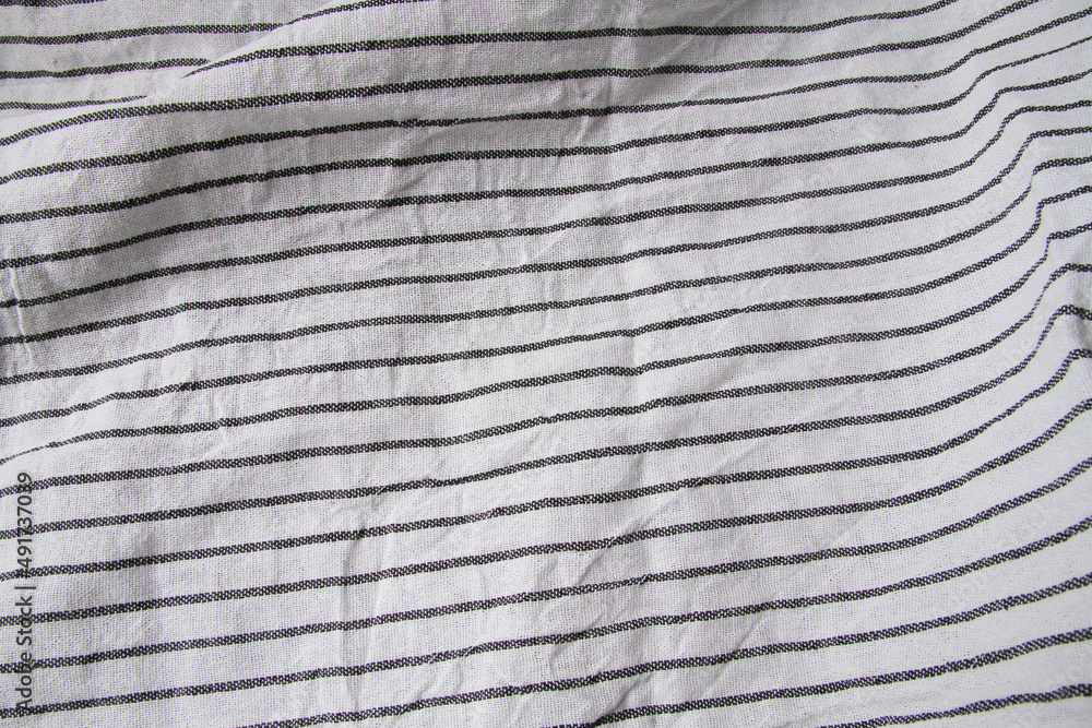 Plaid material. Towel on the table. Wrinkled fabric with stripes. Plaid material. Towel on the table. Wrinkled fabric with stripes.