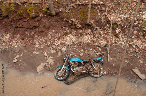 Suzuki Motorcycle rotting in the creek photo