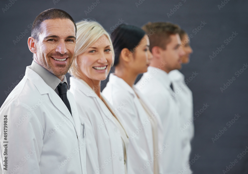 Your first line of defense against illness. Cropped shot of a group of doctors standing in a row. Your first line of defense against illness. Cropped shot of a group of doctors standing in a row.