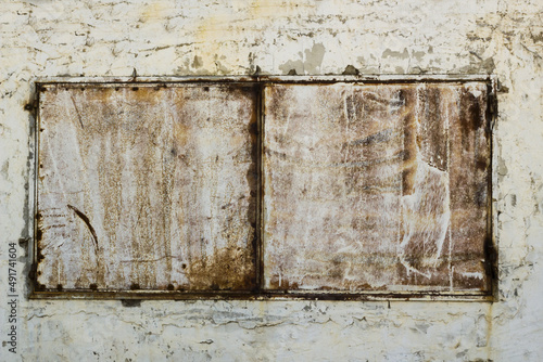 Closed window is made of two rusty and old iron plates,background