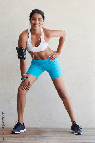 Its time to get your fitness on. Shot of a sporty young woman working out at home.