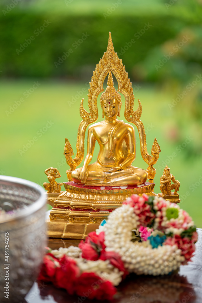 Fototapeta premium Flower garlands, water bowls, perfume and white clay filler for Buddha bathing ceremony on important religious days for Buddhists, New Year's and Songkran Festivals for Asians.