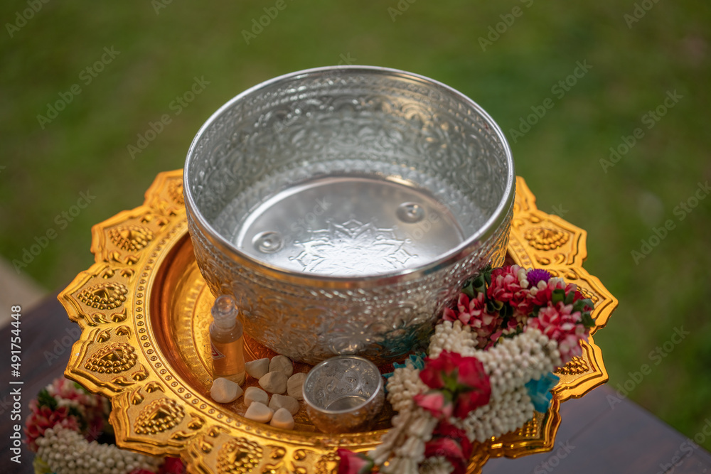 Flower garlands, water bowls, perfume and white clay filler for Buddha bathing ceremony on important religious days for Buddhists, New Year's and Songkran Festivals for Asians. Flower garlands, water bowls, perfume and white clay filler for Buddha bathing ceremony on important religious days for Buddhists, New Year's and Songkran Festivals for Asians.