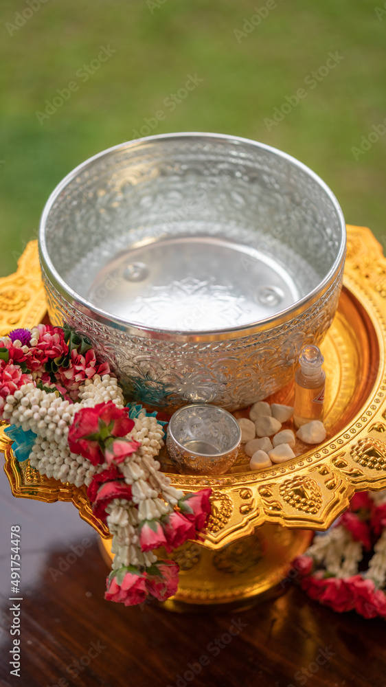 Flower garlands, water bowls, perfume and white clay filler for Buddha bathing ceremony on important religious days for Buddhists, New Year's and Songkran Festivals for Asians. Flower garlands, water bowls, perfume and white clay filler for Buddha bathing ceremony on important religious days for Buddhists, New Year's and Songkran Festivals for Asians.