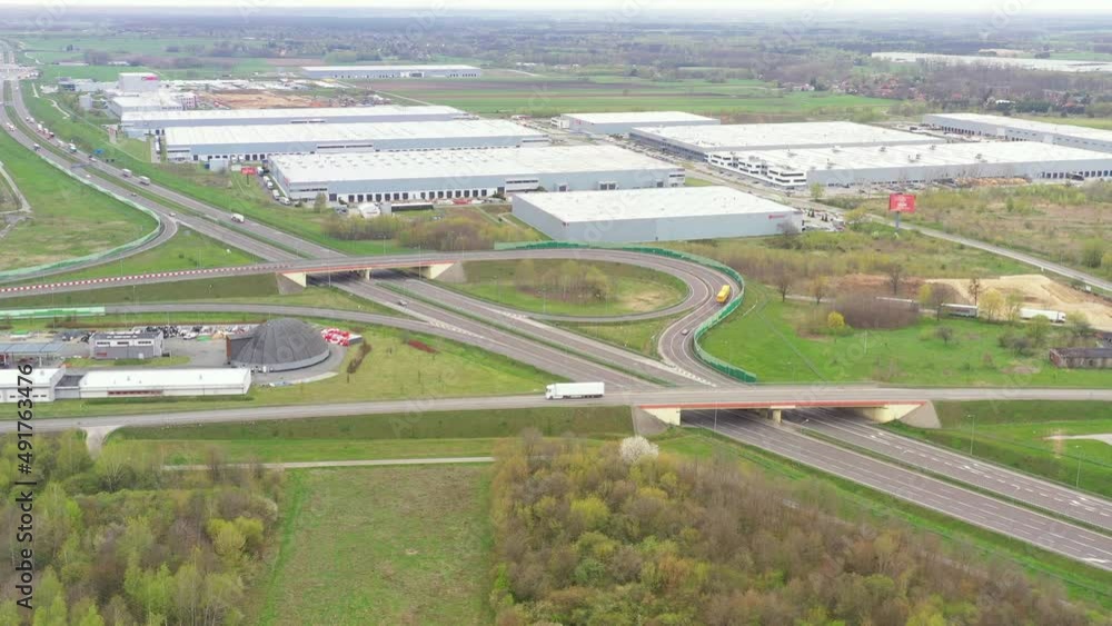 Aerial view of goods warehouse. Logistics center in industrial city zone from above. Aerial view of trucks loading at logistic center. View from drone. Aerial view of goods warehouse. Logistics center in industrial city zone from above. Aerial view of trucks loading at logistic center. View from drone.