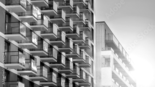 Fragment of modern residential apartment with flat buildings exterior. Detail of new luxury house and home complex. Black and white filter.