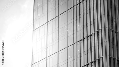 Urban abstract - windowed wall of office building. Detail shot of modern business building in city. Looking up at the glass facade of a skyscraper. Black and white filter.
