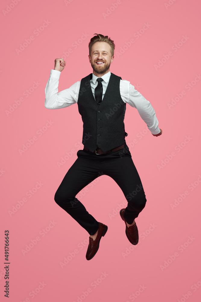Happy businessman jumping and smiling Happy businessman jumping and smiling
