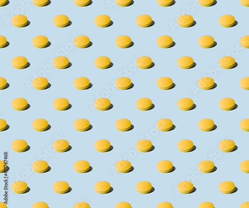 Yellow pills on a blue background. Seamless pattern for the background. Medical pharmacy bright design for presentation packaging, website flyer ,cover, business cards.