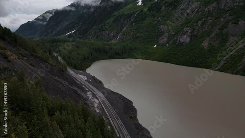 British Columbia Highway cutting through mountains and valleys next to Strohn Lake in Bear Glacier Provincial Park, Canada. Wide angle aerial shot photo