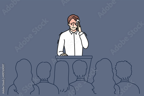 Nervous man feel stressed speaking in front of public. Anxious worried male speaker sweat with pain and anxiety on stage. Concept of audience fear. Flat vector illustration. 