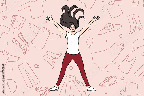 Overjoyed young girl lying among clothes excited with shopping and purchase. Smiling woman shopaholic with garment and apparel. Concept of consumerism and fast fashion. Vector illustration. 