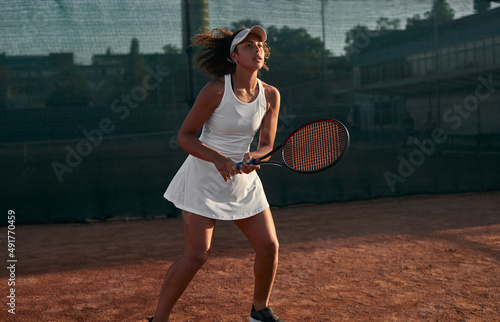 Black sportswoman learning to play tennis © kegfire
