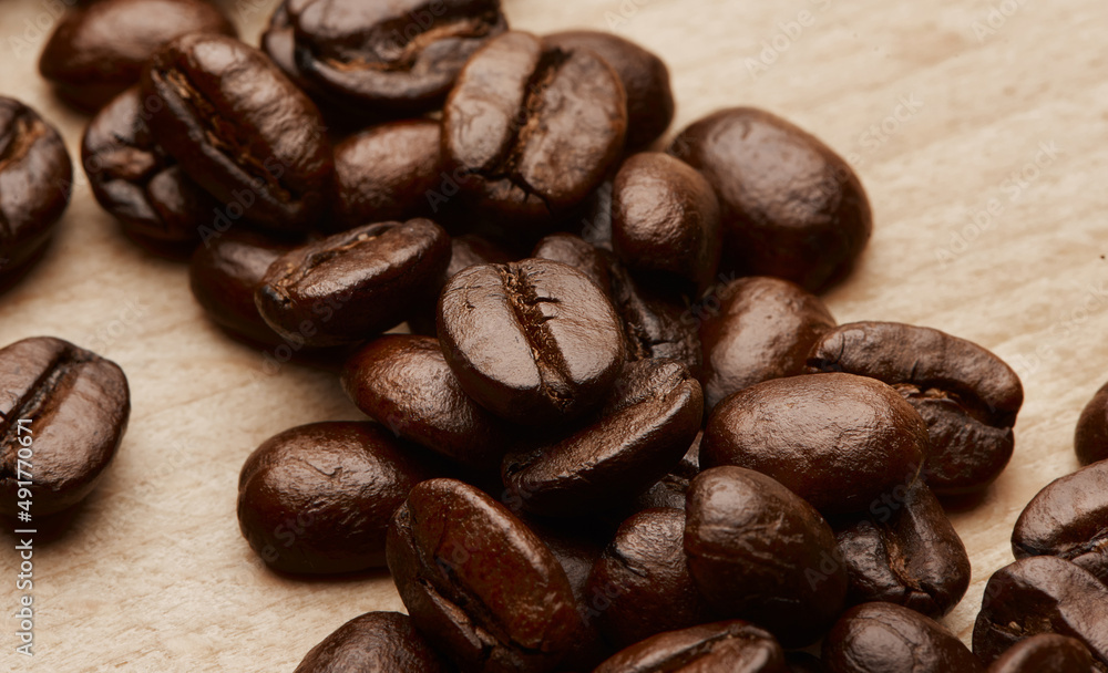 Theyre called energy beans. Still life shot of coffee beans on a wooden countertop. Theyre called energy beans. Still life shot of coffee beans on a wooden countertop.
