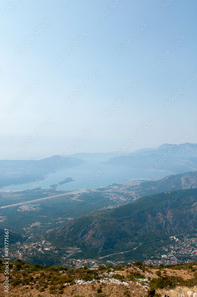 a view on the marina from the top of the mountain through light fog