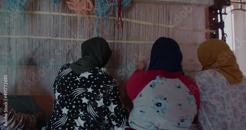 women making traditional carpets in morocco