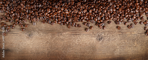 Coffee beans border on dark wooden background. Copy space  top view.