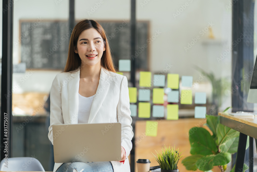 Pretty young business woman sitting on workplace, woman using laptop while sitting at her desk, businesswoman sitting in the office and working on laptop, woman using laptop. Pretty young business woman sitting on workplace, woman using laptop while sitting at her desk, businesswoman sitting in the office and working on laptop, woman using laptop.