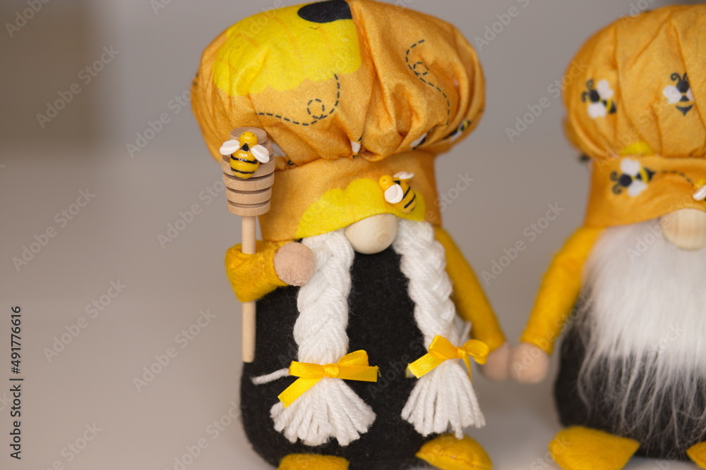Fototapeta premium dwarf, elf, yellow elf, dwarf with a spoon for honey