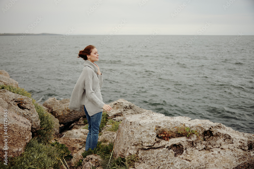 beautiful woman freedom walk on the stone coast Relaxation concept