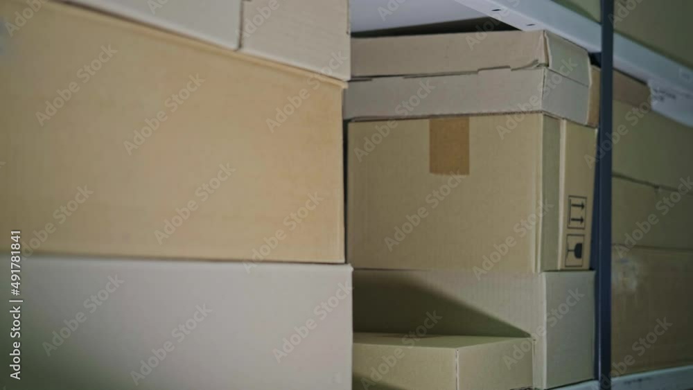 A man steals box in a warehouse. Problems with theft and security in the office A man steals box in a warehouse. Problems with theft and security in the office