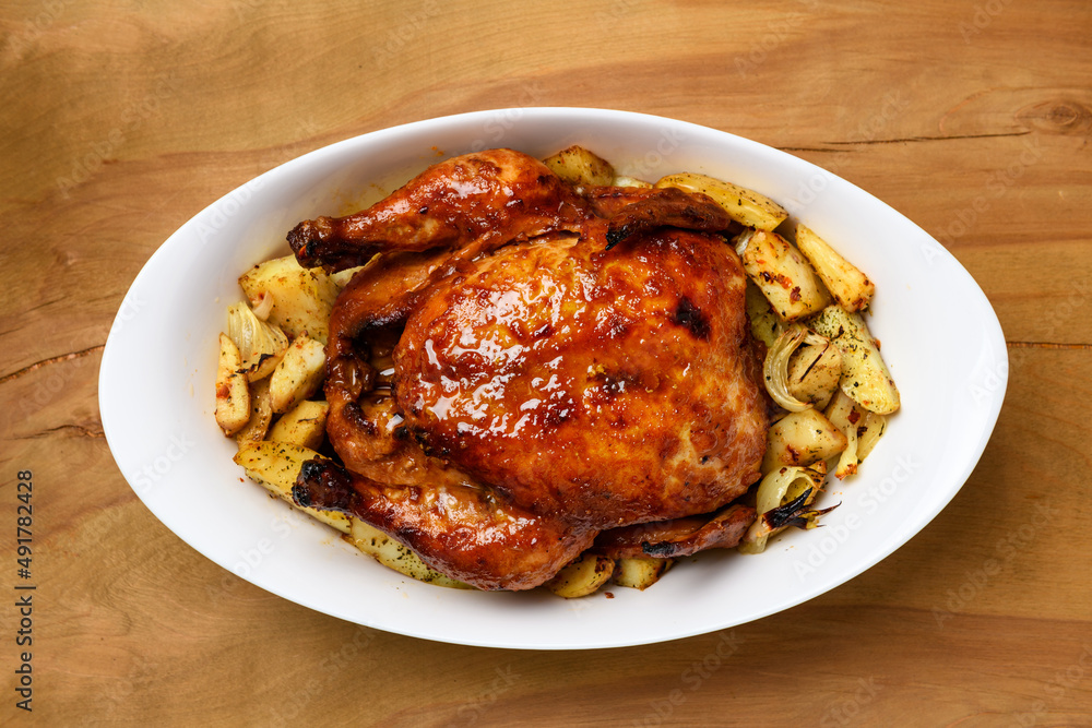 fried chicken meat and roasted potatoes, tasty food on a wooden background