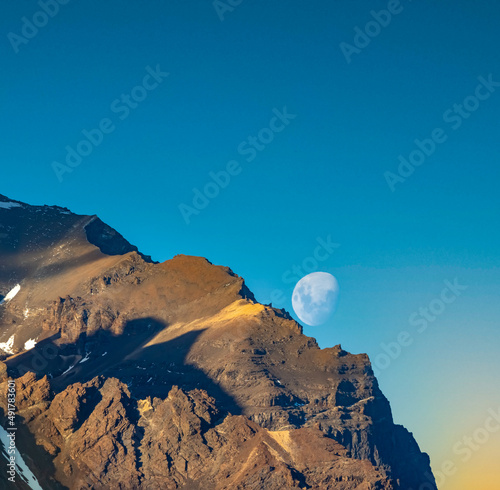 Beautiful clear moon over the distinctive granitze spiky peaks in the Torres del Paine National Park, southern Patagonia, Magallanes, Chile