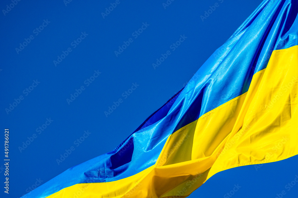 Blue and yellow Ukrainian flag waving on windy day Blue and yellow Ukrainian flag waving on windy day