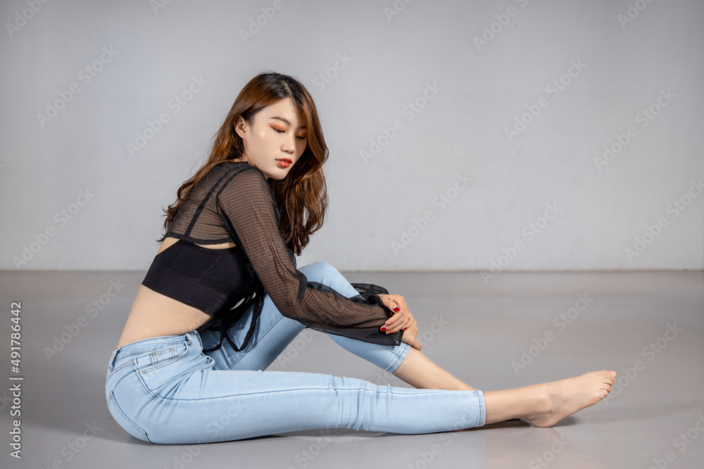 A slim, leggy girl in jeans Stock Photo