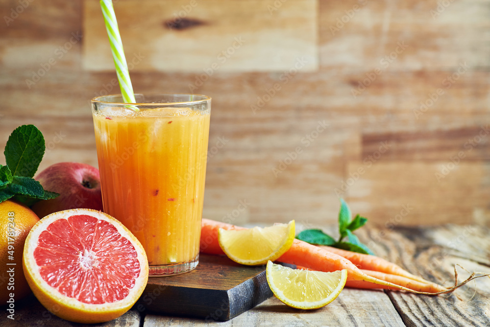 Fruit juice served in glass.V arious fresh fruit juice citrus apple and carrots served in glass on wooden table. Fruit healthy juice for detox. Fruit juice served in glass.V arious fresh fruit juice citrus apple and carrots served in glass on wooden table. Fruit healthy juice for detox.