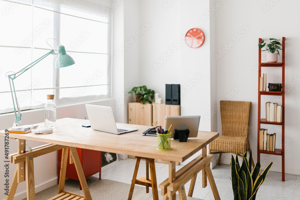 Empty modern workplace - Home office workspace with laptop computer and office supplies - Trendy desk work interior concept Empty modern workplace - Home office workspace with laptop computer and office supplies - Trendy desk work interior concept