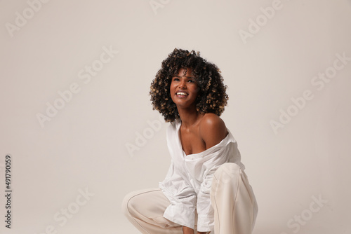 Happy beautiful young woman smiling and posing in the white studio. Isolated.