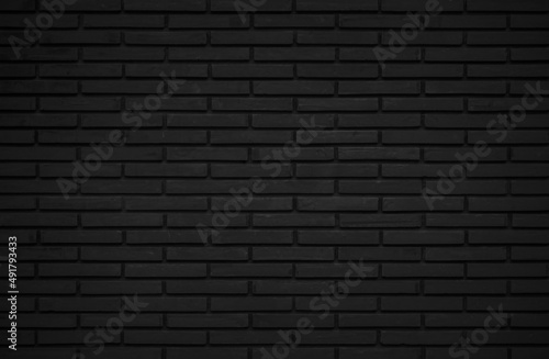 Black brick wall abstract background. Design geometric dark texture room decoration.