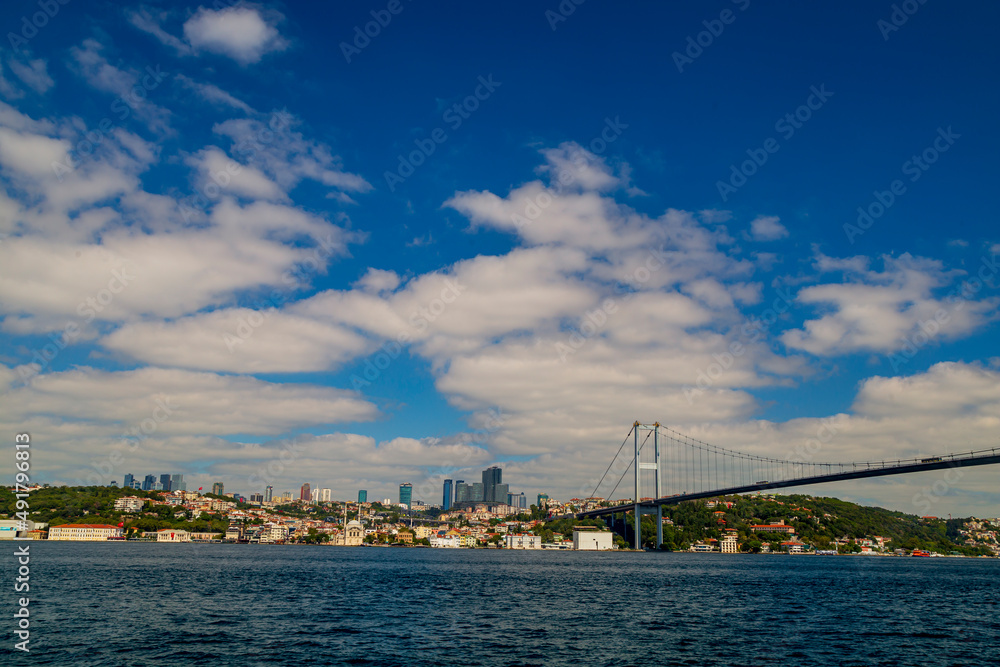 Ferries passing by Bosporus with blue sky and clouds. Istanbul Bosporus Bridge on day time