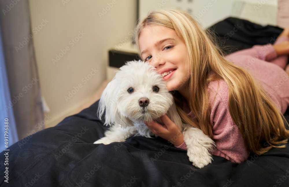 blonde girl lying in bed with her smiling dog looking at the camera blonde girl lying in bed with her smiling dog looking at the camera