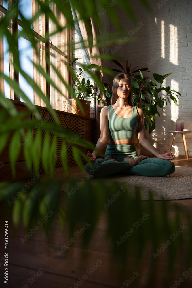 A woman doing yoga at home. A woman doing yoga at home.