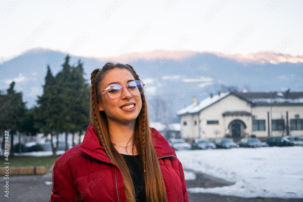 young woman with glasses in the town square