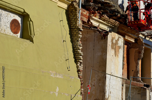 demolition of an apartment building worker on a forklift using a jackhammer. creates an apocalyptic scene. clearing work after the bombing. reconstruction of the historic castle building