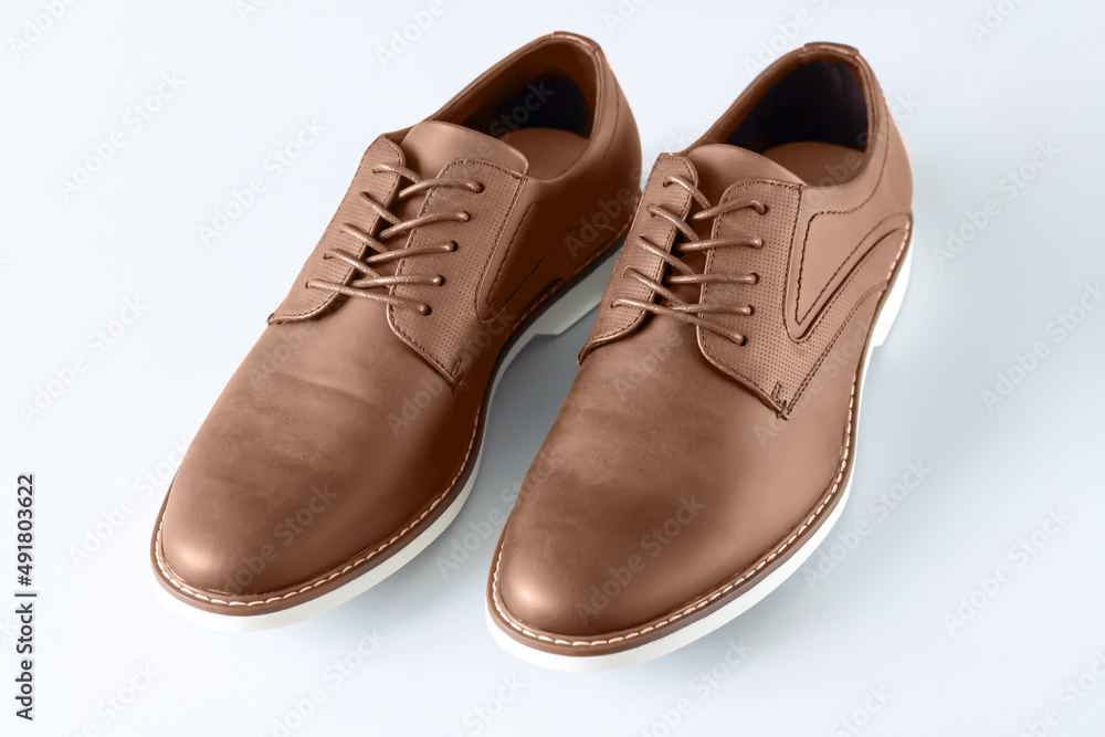 Casual male leather bown shoes on gray background Casual male leather bown shoes on gray background