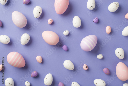Wallpaper Mural Top view of a lot of multicolored Easter eggs different size with stripes and dots on the pastel violet isolated background Torontodigital.ca