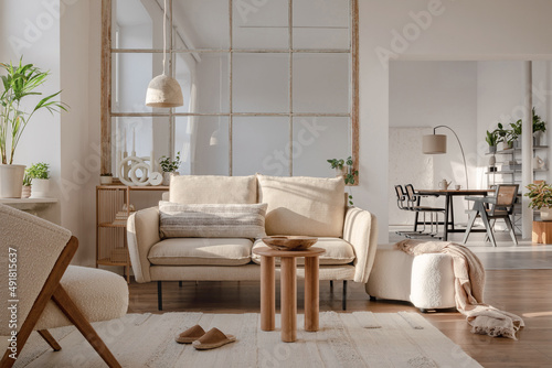 Stylish compositon of modern living room interior with sofa, plants, wooden commode, side table and elegant home accessories. Home staging. Template. Copy space. © FollowTheFlow