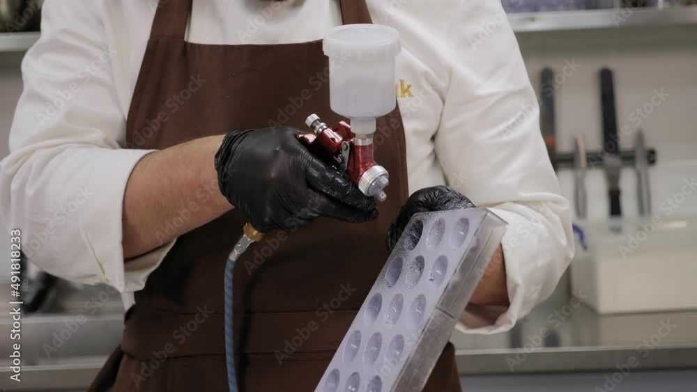 Closeup of a professional pastry chef making chocolate candies