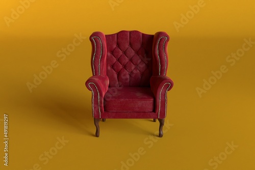 Red velvet armchair of old design on short legs with high back isolated on yellow background.