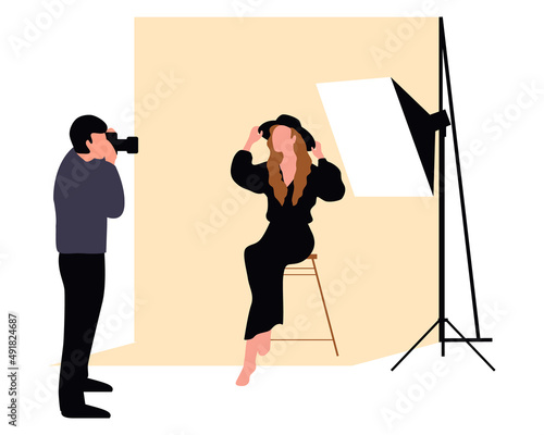 Professional photographers taking pictures. Men and woman models posing in professional photography studio with cameras and light tripods.